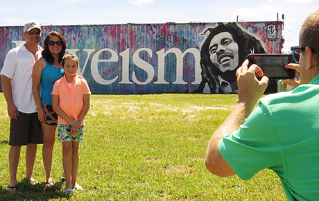 Taking a family photo at Bob Marley mural