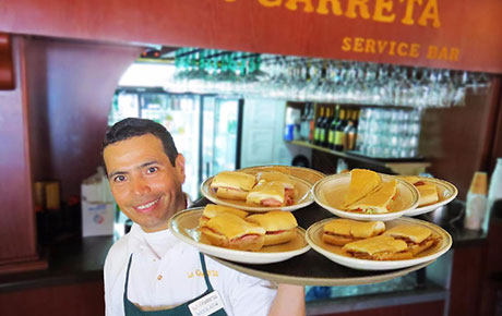 La Carreta waiter with Cuban Sandwiches